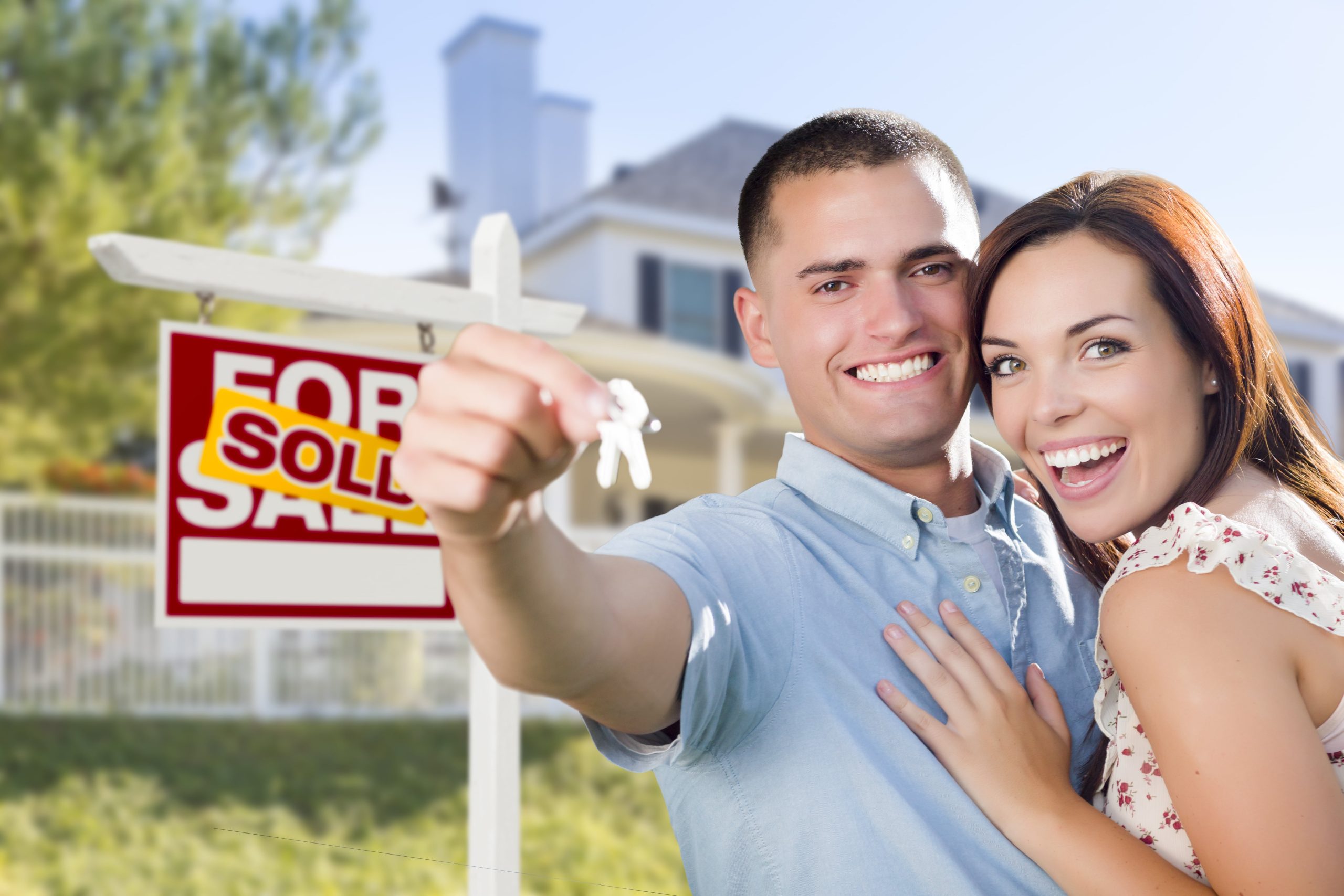 Military couple in front of sold house